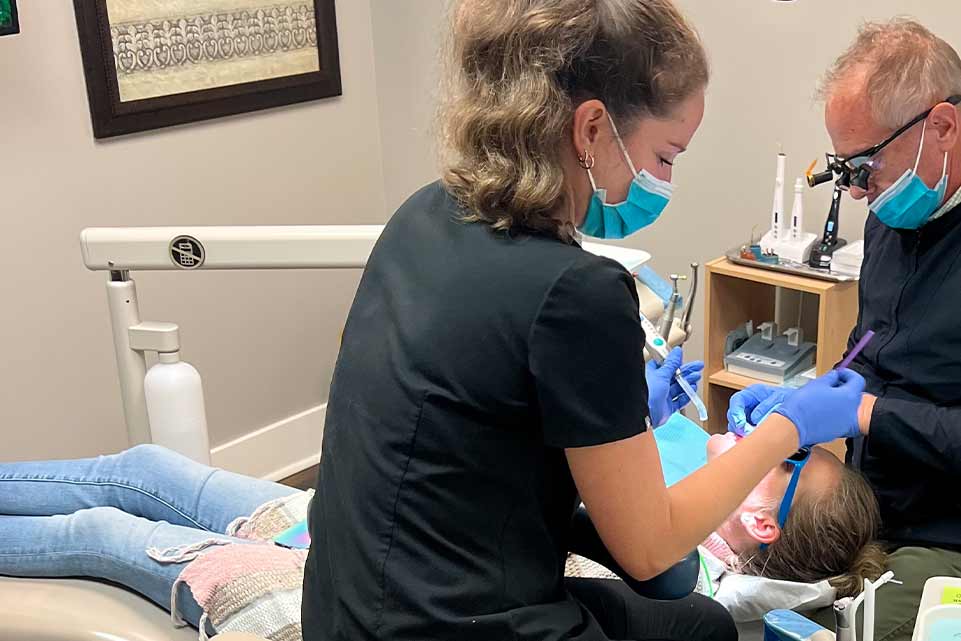 young woman patient receiving a dental cleaning in Charleston, SC