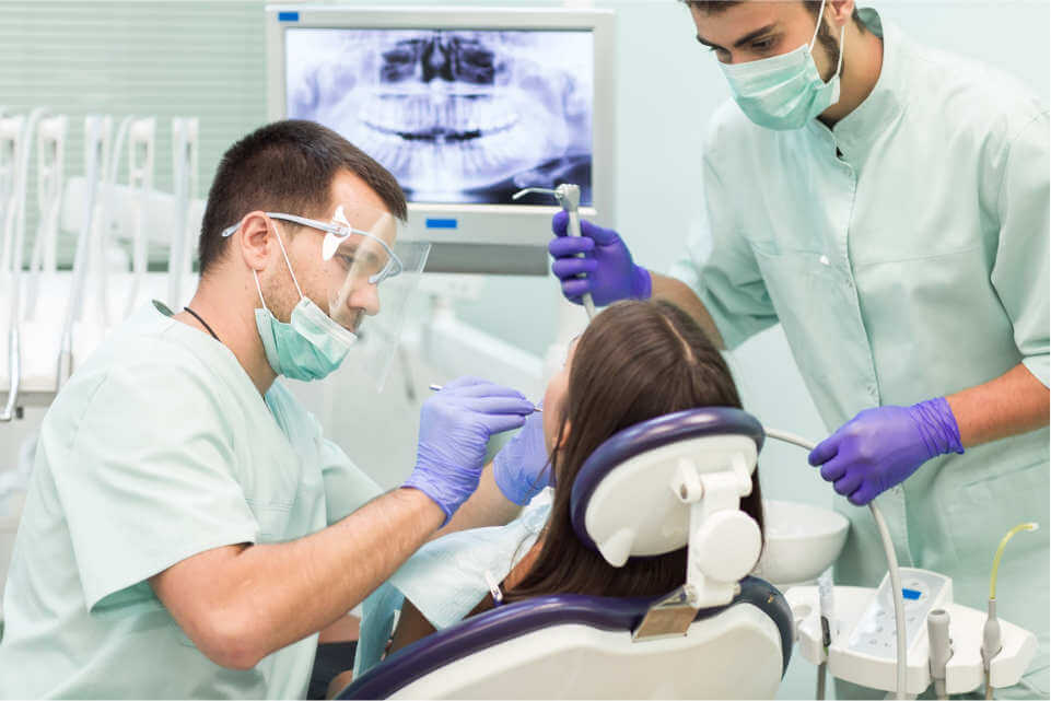 Charleston, SC dentist and hygienist working on patient